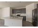 Well-equipped kitchen with quartz countertops, stainless steel appliances, and stylish cabinetry at 2205 S 241St Dr, Buckeye, AZ 85326