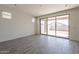 Bright living room with tile flooring and a sliding glass door leading to the backyard at 2205 S 241St Dr, Buckeye, AZ 85326