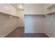 Walk-in closet with carpet flooring, baseboards, shelving, and clothes rods for storage at 2205 S 241St Dr, Buckeye, AZ 85326
