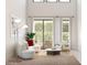 Stylish living area with a curved sofa, accent chair, modern lighting, and a cozy rug, perfect for relaxation at 2381 W Los Arboles Pl, Chandler, AZ 85224