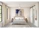 Serene bedroom with a minimalist design, featuring soft lighting, neutral tones, and a modern ceiling fan at 2381 W Los Arboles Pl, Chandler, AZ 85224