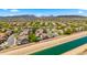 Sprawling aerial view of a meticulously planned community with mountain views and canal at 2405 W Cordia Ln, Phoenix, AZ 85085