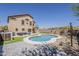 Stunning backyard featuring a sparkling pool, artificial grass, and outdoor seating area at 2405 W Cordia Ln, Phoenix, AZ 85085
