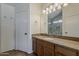 This bathroom features a light brown vanity with drawers and a large mirror with vanity lighting at 2405 W Cordia Ln, Phoenix, AZ 85085