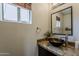 Stylish half-bath with a vessel sink, granite countertops, and modern fixtures at 2405 W Cordia Ln, Phoenix, AZ 85085