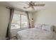 Bright bedroom with a large window offering desert views and a ceiling fan at 2405 W Cordia Ln, Phoenix, AZ 85085