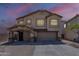 Charming two-story home featuring stone accents, a two-car garage, and manicured landscaping at 2405 W Cordia Ln, Phoenix, AZ 85085