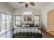 This main bedroom features a ceiling fan, a picture window, and dark wood floors at 2405 W Cordia Ln, Phoenix, AZ 85085