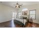 This main bedroom features a ceiling fan, wood floors, and access to a balcony at 2405 W Cordia Ln, Phoenix, AZ 85085