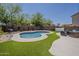 Relaxing backyard with a private pool surrounded by lush artificial grass at 2405 W Cordia Ln, Phoenix, AZ 85085