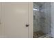 This shower features white marble-look tile, a pebble floor, and a glass surround at 2405 W Cordia Ln, Phoenix, AZ 85085