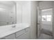 Bright bathroom featuring a white vanity with a sink and a door leading to a bedroom at 24252 W Pecan Rd, Buckeye, AZ 85326