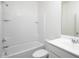 Clean white bathroom with tub-shower combo, vanity with white cabinets, and tile accents at 24252 W Pecan Rd, Buckeye, AZ 85326
