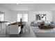 Open-concept living and dining area features modern decor and plenty of natural light at 24252 W Pecan Rd, Buckeye, AZ 85326