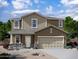 Charming two-story home featuring a neutral color palette, stone accents, and a two-car garage at 24253 W Hidalgo Ave, Buckeye, AZ 85326