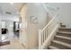Bright foyer showcases a stairway with white railings and an open floor plan to the living area at 2542 W Gaby Rd, Phoenix, AZ 85041