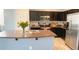 Well-equipped kitchen boasts dark cabinetry, stainless steel appliances, and a spacious island for meal preparation at 2542 W Gaby Rd, Phoenix, AZ 85041