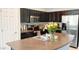 Modern kitchen featuring dark cabinets, stainless steel appliances, and a center island perfect for cooking and entertaining at 2542 W Gaby Rd, Phoenix, AZ 85041