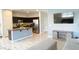 Open-concept living room with sleek flooring that flows into the kitchen area, creating a great space for entertaining at 2542 W Gaby Rd, Phoenix, AZ 85041