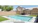Inviting backyard pool with artificial grass, a shaded pergola, and ample space for outdoor entertaining and relaxation at 2542 W Gaby Rd, Phoenix, AZ 85041