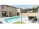Beautiful backyard featuring a refreshing swimming pool, artificial grass, and a covered patio area for outdoor enjoyment at 2542 W Gaby Rd, Phoenix, AZ 85041