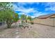 Landscaped backyard featuring a fire pit, desert landscaping and a block wall for privacy at 2845 N 104Th Ave, Avondale, AZ 85392