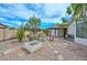 Landscaped backyard featuring decorative stone, raised beds, and a covered patio at 2845 N 104Th Ave, Avondale, AZ 85392