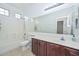 Bright bathroom featuring a shower-tub combo, white cabinets, and a large mirror at 2845 N 104Th Ave, Avondale, AZ 85392