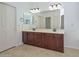 Bathroom with a double sink vanity with dark wood cabinetry at 2845 N 104Th Ave, Avondale, AZ 85392