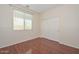 Bedroom featuring laminate flooring, a window, and a closet at 2845 N 104Th Ave, Avondale, AZ 85392