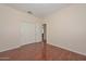 Bedroom boasts wood-look floors, neutral walls and closet with sliding doors at 2845 N 104Th Ave, Avondale, AZ 85392