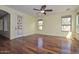 Bright living room with hardwood floors, ceiling fan, and natural light from multiple windows at 2845 N 104Th Ave, Avondale, AZ 85392