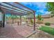 Covered patio with brick flooring, a trellis, and access to the landscaped backyard at 2845 N 104Th Ave, Avondale, AZ 85392