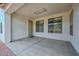 Covered patio featuring concrete flooring and a security door leading to the home's interior at 2845 N 104Th Ave, Avondale, AZ 85392