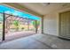 Covered patio with concrete flooring and a view of the brick-paved patio and backyard at 2845 N 104Th Ave, Avondale, AZ 85392