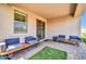 Covered outdoor living space showcasing outdoor seating, tile flooring, and a seamless indoor-outdoor flow at 31435 N 130Th Ave, Peoria, AZ 85383