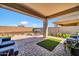 Inviting back patio with ample outdoor seating, brick flooring, and a stainless steel gas grill at 31435 N 130Th Ave, Peoria, AZ 85383