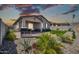This backyard features a covered patio, desert landscaping, and a synthetic grass area at 31435 N 130Th Ave, Peoria, AZ 85383