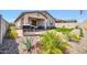 Beautiful backyard featuring decorative plants, artificial lawn, and a stainless steel gas grill at 31435 N 130Th Ave, Peoria, AZ 85383