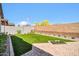 Spacious backyard with artificial grass, brick perimeter wall, and well-manicured landscaping at 31435 N 130Th Ave, Peoria, AZ 85383