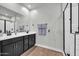 Elegant bathroom with double vanity, modern fixtures, and a glass-enclosed shower at 31435 N 130Th Ave, Peoria, AZ 85383