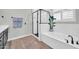 Modern bathroom featuring a soaking tub, a glass-enclosed shower, and contemporary fixtures at 31435 N 130Th Ave, Peoria, AZ 85383