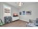 room with ample natural light, wood-look floors, and a ceiling fan at 31435 N 130Th Ave, Peoria, AZ 85383