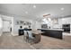 Open-concept dining area featuring a wooden table, stylish seating, and views of the kitchen and living spaces at 31435 N 130Th Ave, Peoria, AZ 85383