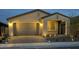Charming single-story home exterior with a two-car garage and beautiful paver driveway at 31435 N 130Th Ave, Peoria, AZ 85383