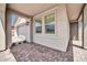 View of covered porch with brick floor, windows, recessed lighting and doorway to the front entry at 31435 N 130Th Ave, Peoria, AZ 85383