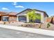 Single-story house featuring desert landscaping, a gray two-car garage and a brick driveway at 31435 N 130Th Ave, Peoria, AZ 85383