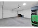 Well-maintained garage interior with epoxy floors, storage shelving, and an automatic door at 31435 N 130Th Ave, Peoria, AZ 85383