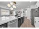 Open kitchen with an island with a black base, white countertop, and modern pendant lighting at 31435 N 130Th Ave, Peoria, AZ 85383