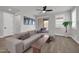 Comfortable living room with a neutral-toned sofa, and sliding glass doors to the outdoor patio at 31435 N 130Th Ave, Peoria, AZ 85383